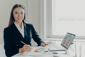 Professional business lady in headset preparing for online presentation